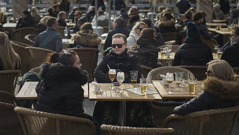 ARCHIV - Menschen sitzen vor einem Restaurant am Bürgerplatz in Stockholm. Foto: Andres Kudacki/AP/dpa