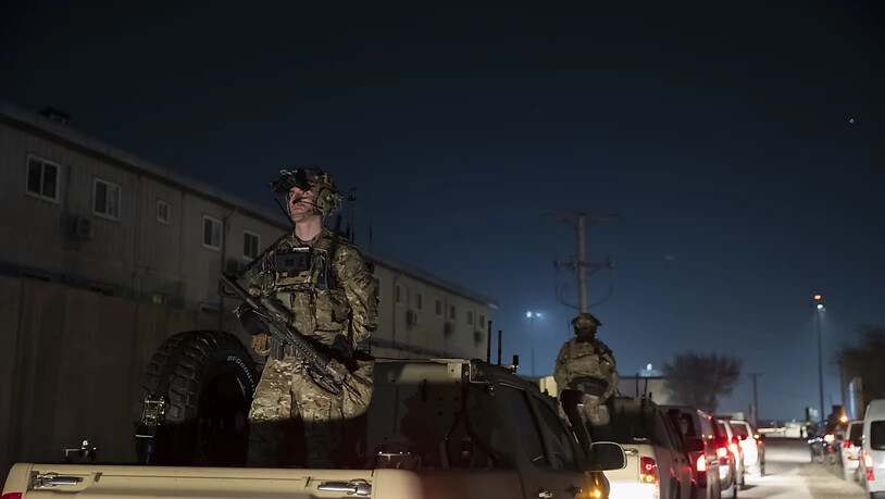 ARCHIV - Bewaffnete Soldaten stehen Wache in der Fahrzeugkolonne für Präsident Donald Trump, der während eines Überraschungsbesuchs am Thanksgiving Day bei den Truppen auf dem Bagram Air Field in Afghanistan spricht. Foto: Alex Brandon/AP/dpa
