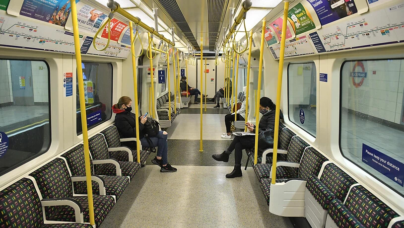 FILED - Passengers sit in an almost empty subway train on the District Line in central London. Photo: Dominic Lipinski/PA Wire/dpa