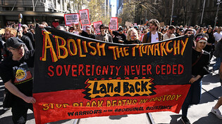 People holding a banner participate in an anti-monarchy protest in Melbourne, Thursday, September 22, 2022. (AAP Image/Joel Carrett) NO ARCHIVING
