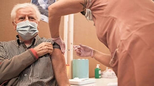 Für Impfung entschieden: Ein Glarner lässt sich im Impfzentrum in Ennenda die Spritze mit dem Corona-Impfstoff in den Oberarm stechen.