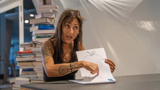 Eine kleine Lektion: Was fängt mit A an? «A wie Apfel», sagt Sandra Fetz und zeigt zum Thema Lesen und Schreiben auf das Bild mit dem Buchstaben A.