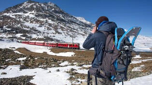 Den «Trenino rosso» im Fokus: Eisenbahnfotograf Ennio Kofler beim Fotografieren eines nordwärts fahrenden Zuges auf dem Berninapass. 