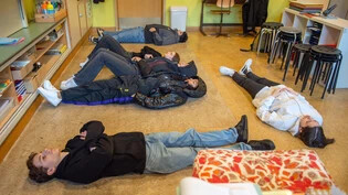 Eine Lektion in Langeweile: Die Jugendlichen der 3. Oberstufe des Florentini Schulhauses in Chur legen sich für ein paar Minuten auf den Boden und schauen an die Decke. Die verschiedenen Erfahrungen teilen sie danach in der Gruppe. 